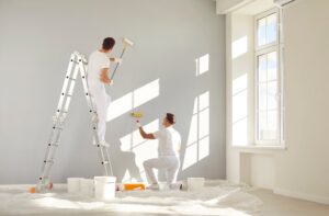 Painting Commercial business. Two Male Workers painting commercial office space.