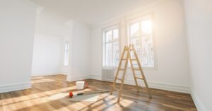 Interior Painting. Freshly painted white room. Ladder and window in image.