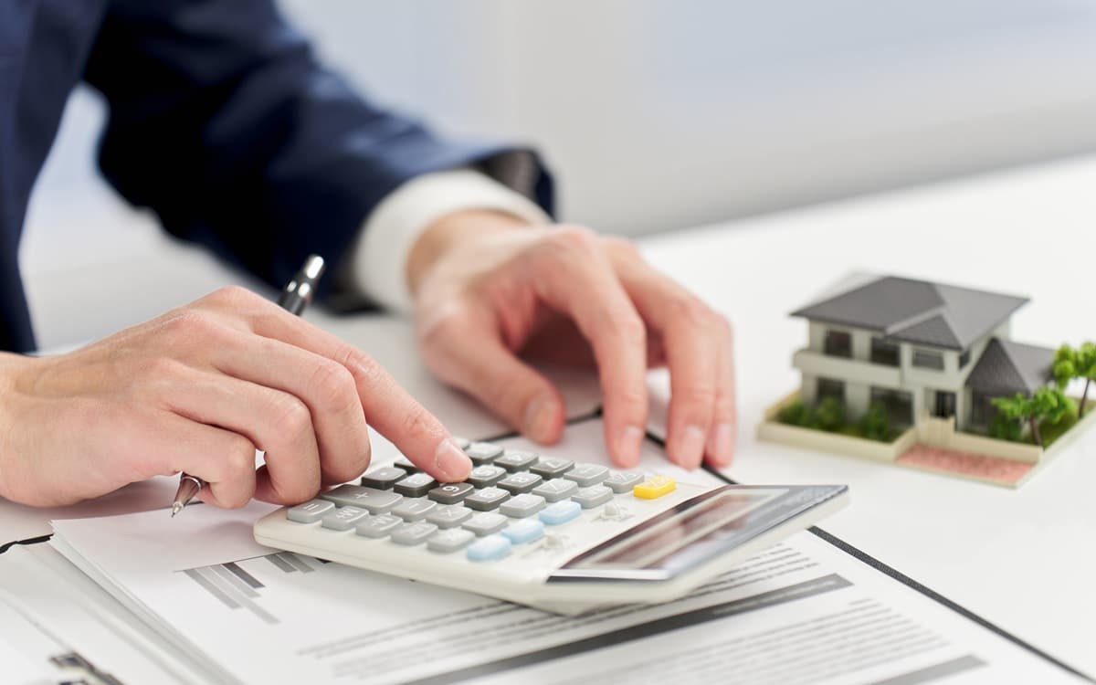 Businessman calculating money related to real estate