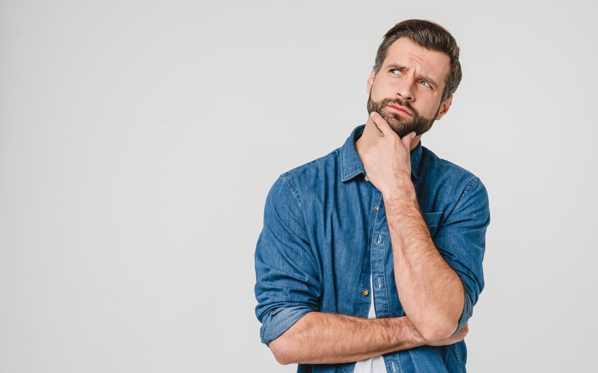 Pensive thoughtful contemplating caucasian young man thinking about future, planning new startup looking upwards isolated in white background